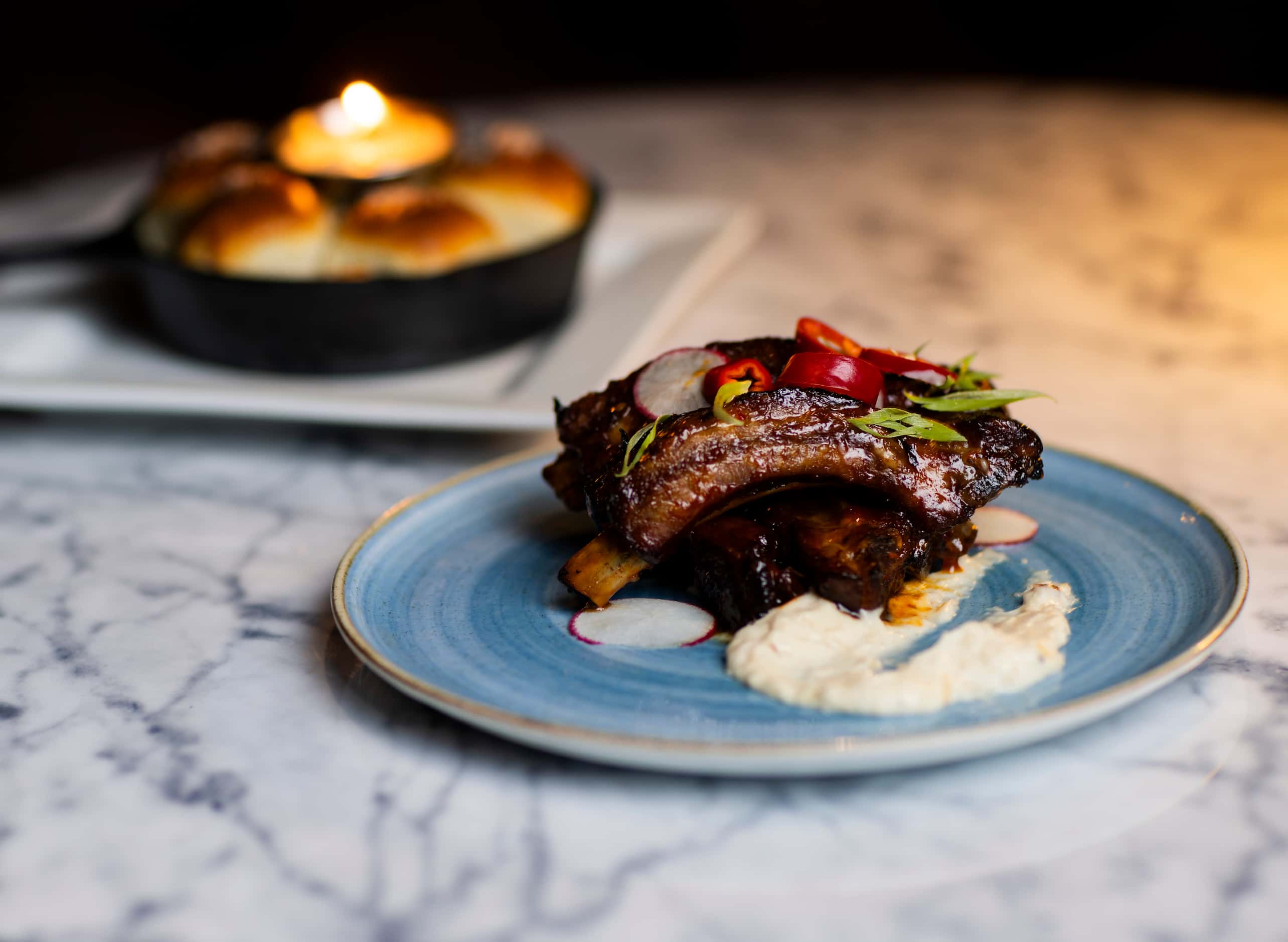 The Wildred's Asian Sticky Ribs come with fresnos, radish, chives and garlic aioli.