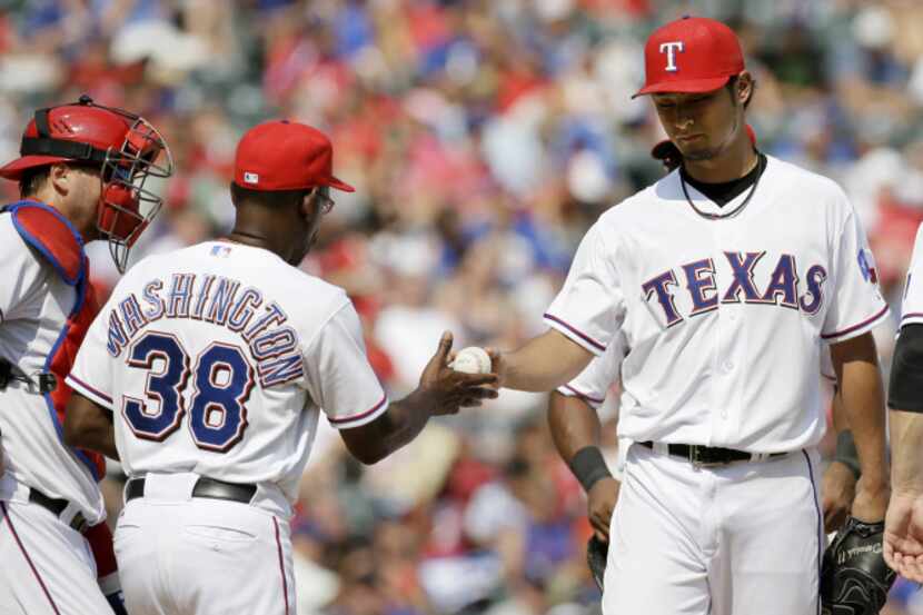 Texas Rangers manager Ron Washington (38) takes the ball from starting pitcher Yu Darvish,...