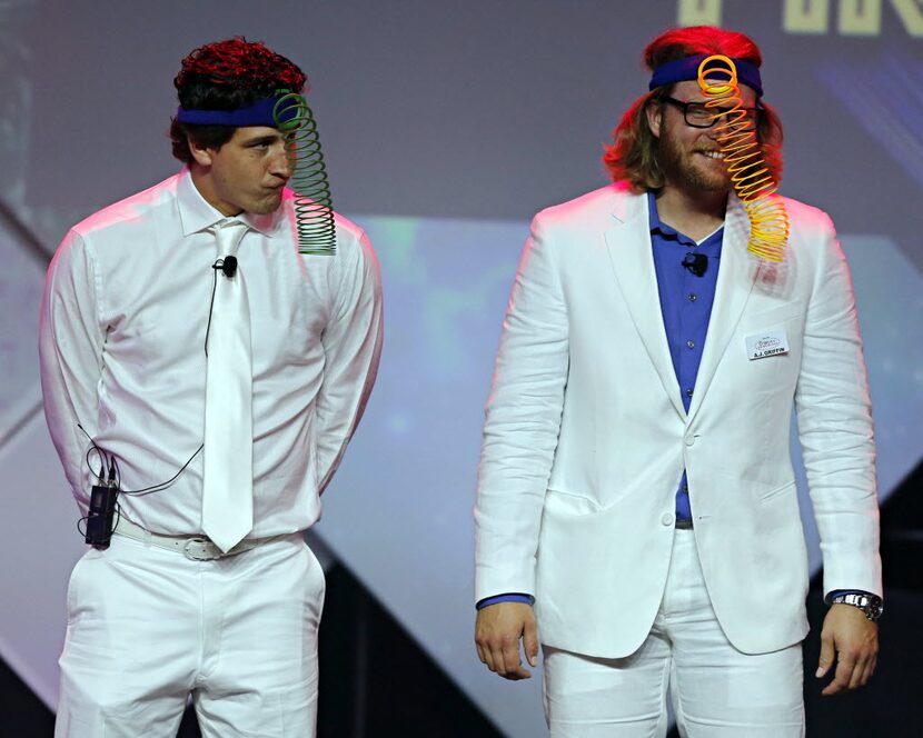 Texas Rangers starting pitchers Derek Holland (left) and A.J. Griffin try to balance Slinkys...