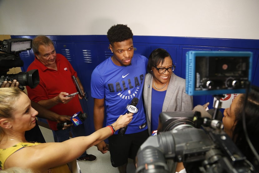 Dallas Mavericks point guard Dennis Smith Jr. with team CEO Cynt Marshall at a DISD...