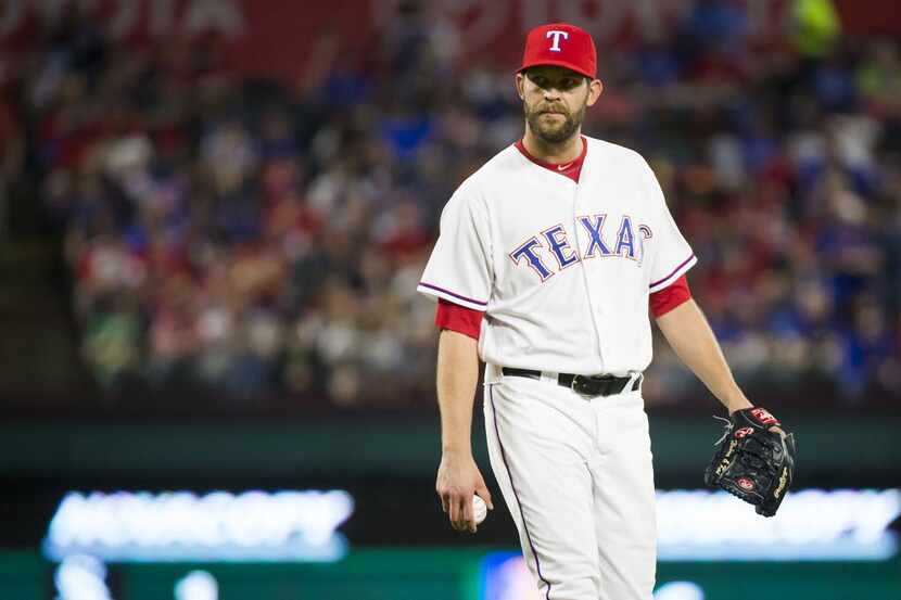 Texas Rangers relief pitcher Tom Wilhelmsen prepares to face the next hitter after giving up...