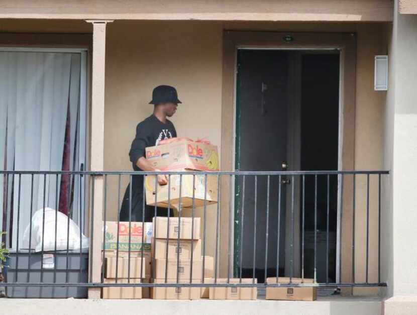 
After a delivery by the North Texas Food Bank on Thursday, a man carried boxes of food into...