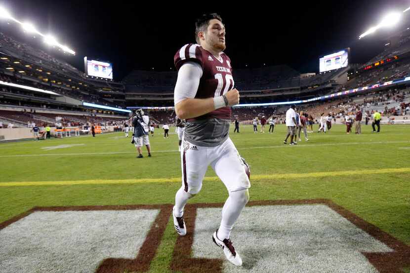 Texas A&M Aggies quarterback Jake Hubenak (10) runs off the field following his second half...