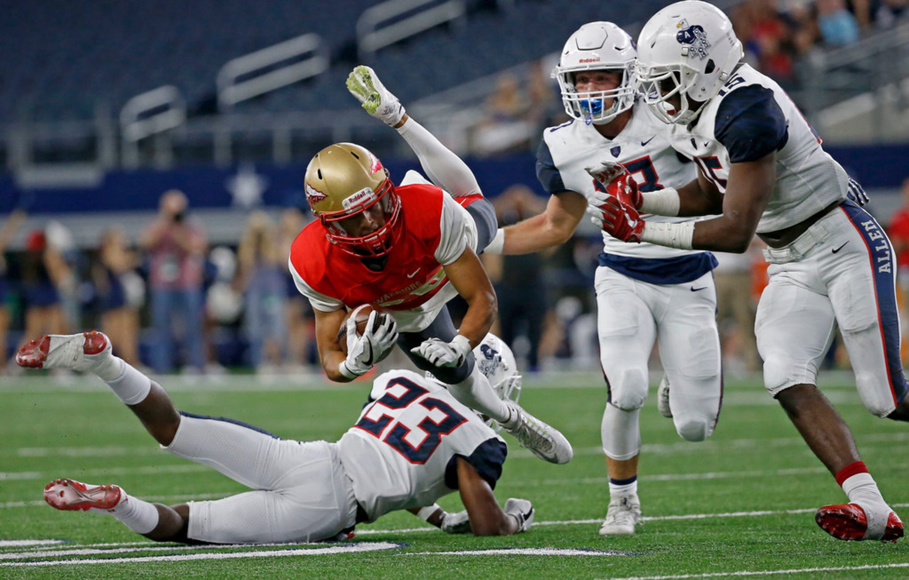 South Grand Prairie's Elias Sanchez (20) is tackled by Allen's Mo Perkins (23) during the...