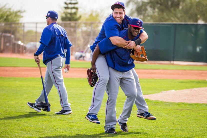Texas Rangers third baseman Joey Gallo gets a piggyback ride off the field from infielder...