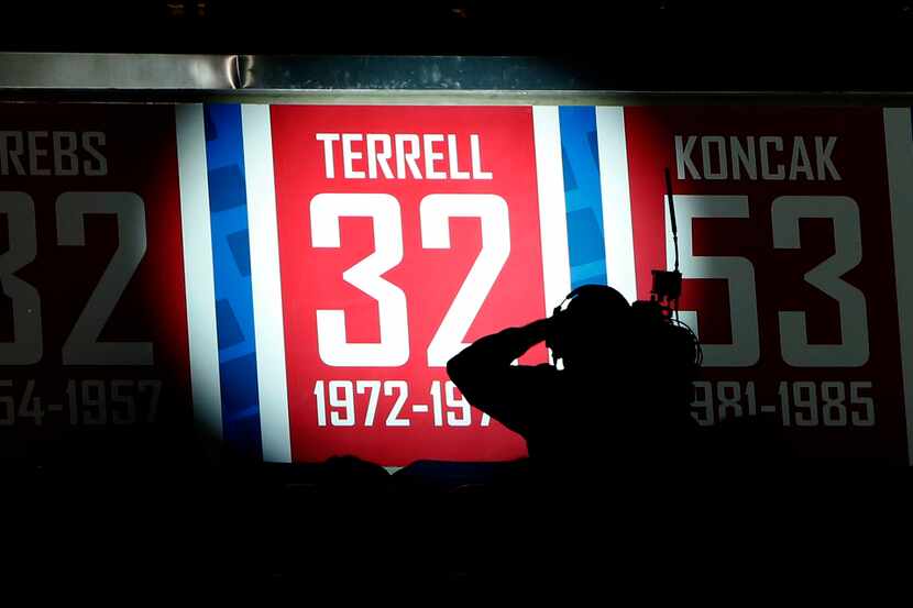 A videographer records the unveiling of jersey number 32 honoring SMU legend Ira Terrell...