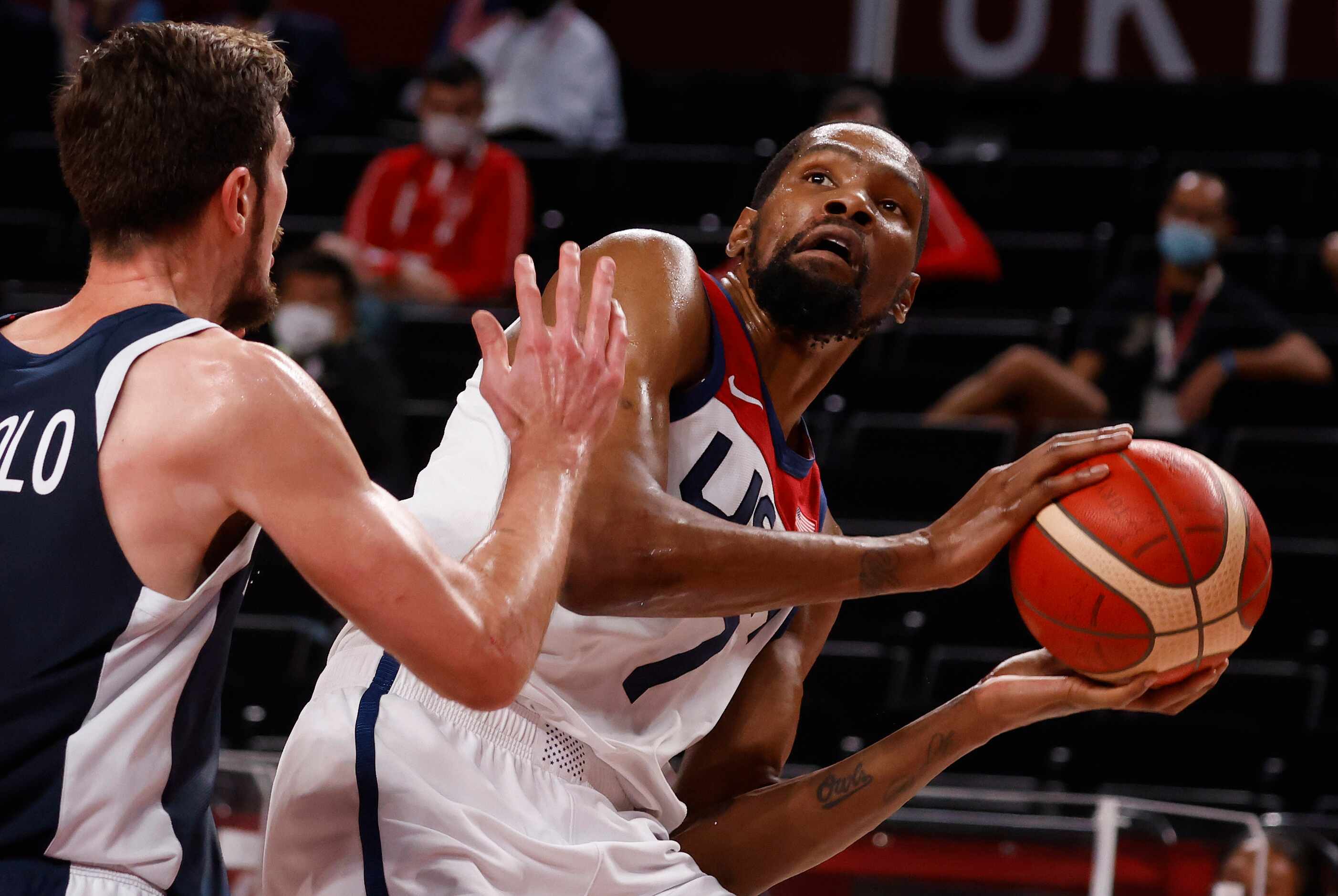 USA’s Kevin Durant (7) steps back to take a shot in front of France’s Nando de Colo (12)...
