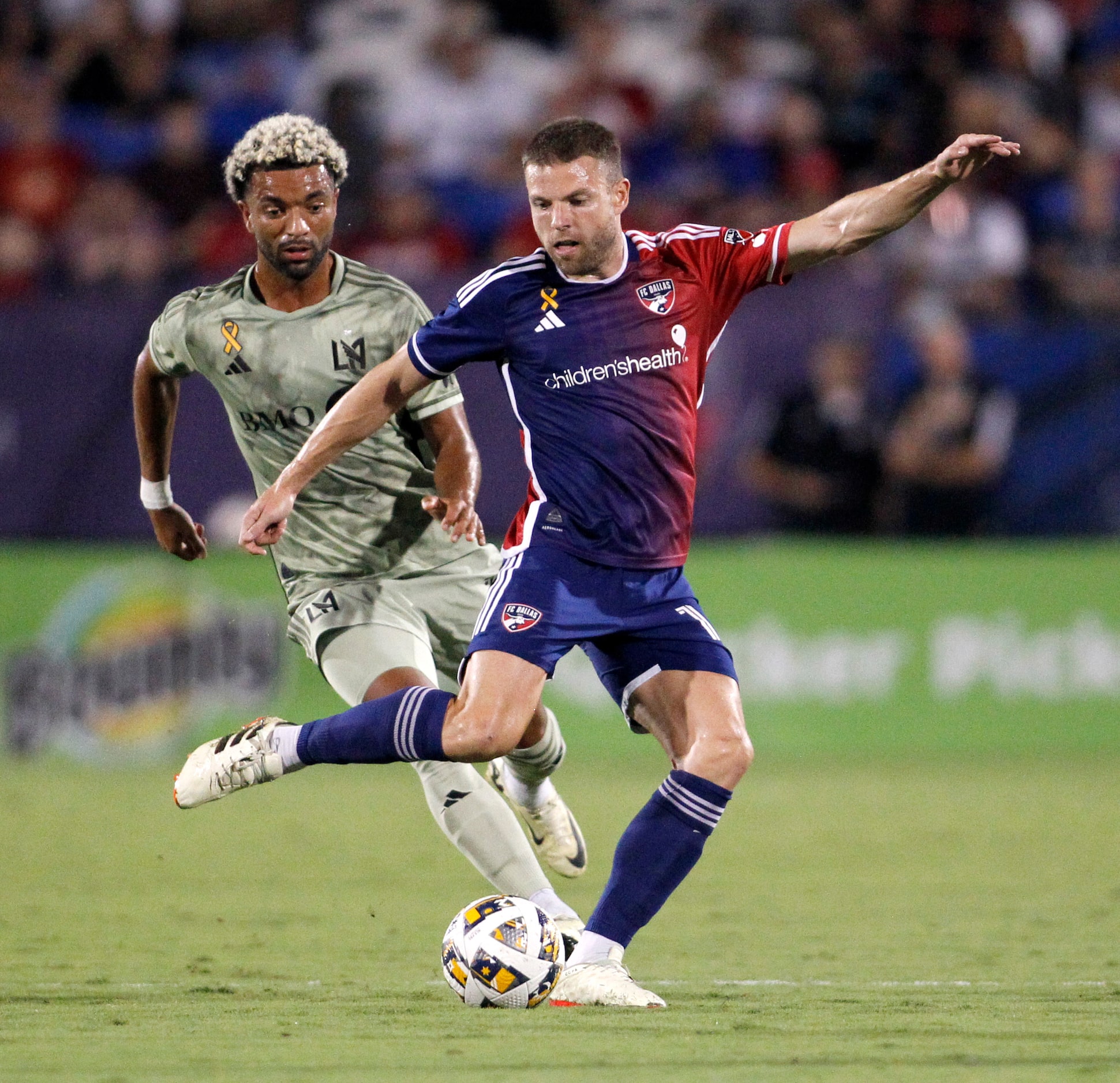 FC DALLAS midfielder Asier Illarramendi (14), center, passes the ball to a teammate as LAFC...