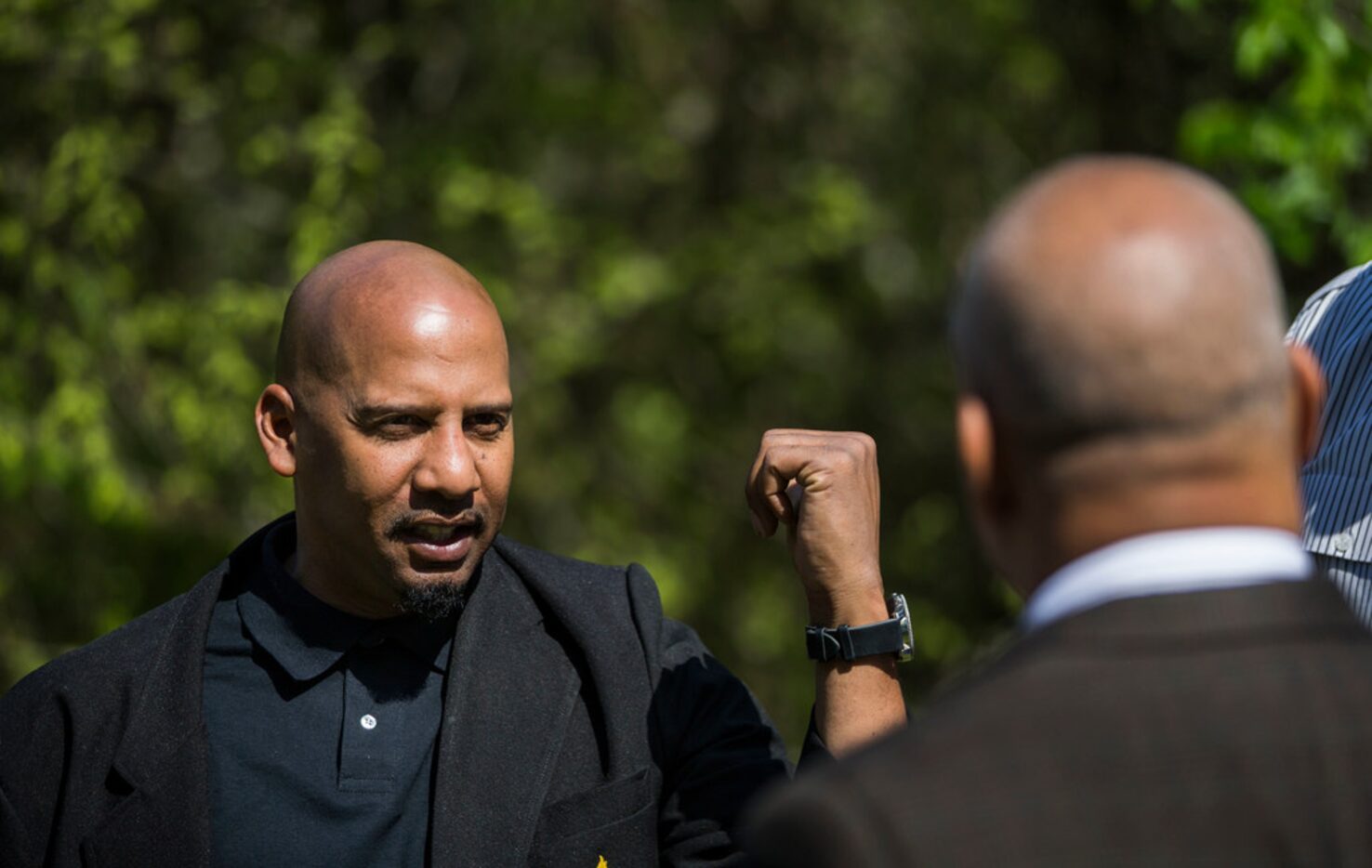 Willie F. Johnson Jr. (left), principal of South Oak Cliff High School, speaks with property...