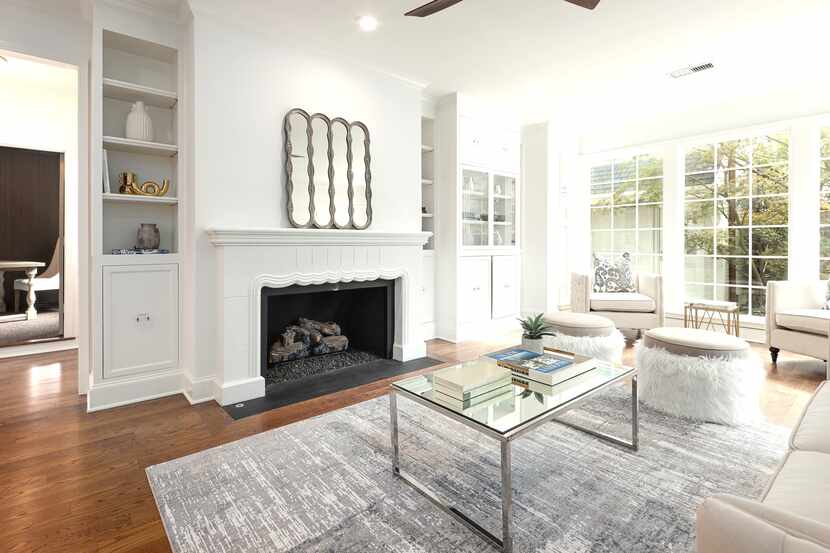 Family room with large fireplace and built-in bookshelves.