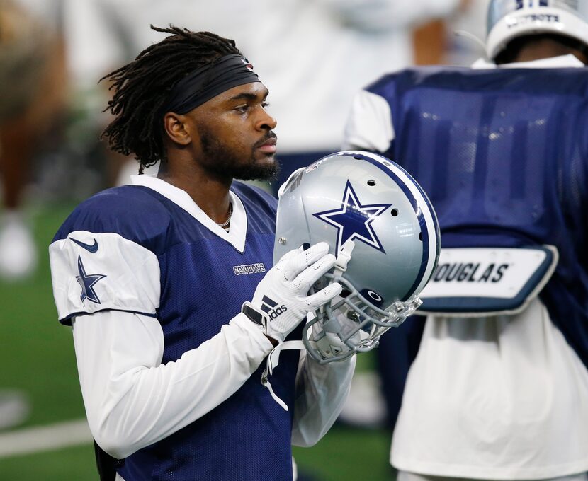 Dallas Cowboys cornerback Trevon Diggs (31) prepares to put his helmet on for the next play...