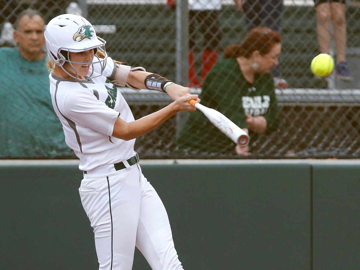 Prosper catcher Elizabeth Moffitt (6) hits one out ot the park for the games first run in...