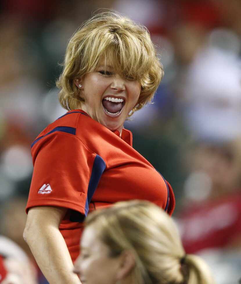 A Texas Rangers fan dances in between inning in a game against the Detroit Tigers at Globe...