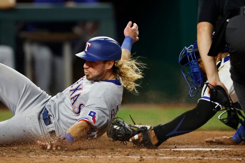 Texas Rangers' Travis Jankowski, left, is tagged out at home plate by Kansas City Royals...