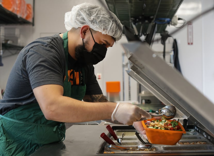 Josh Lagunas prepares a salad at Salad and Go in Plano on May 1, 2021.