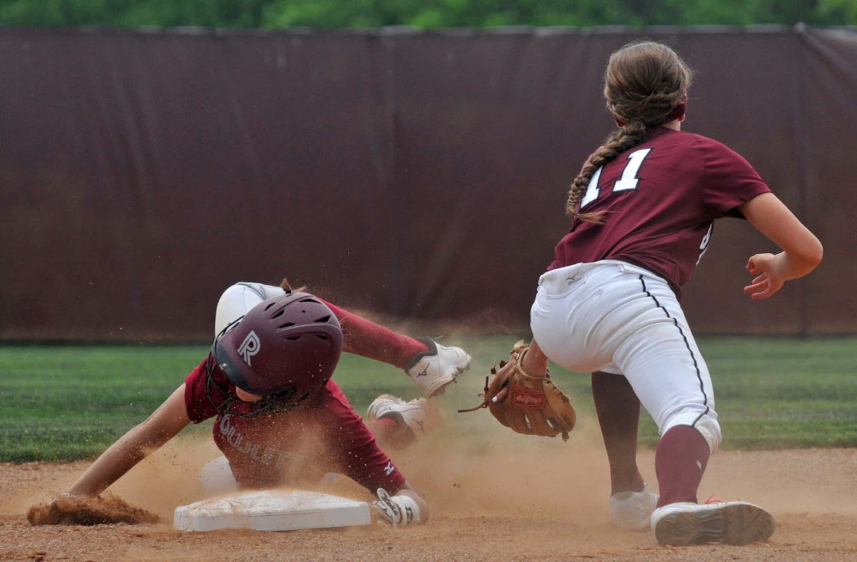 Rowlett's Pierson Jones (12) safely takes second base past Mesquite's Lindy Kennedy (11)...
