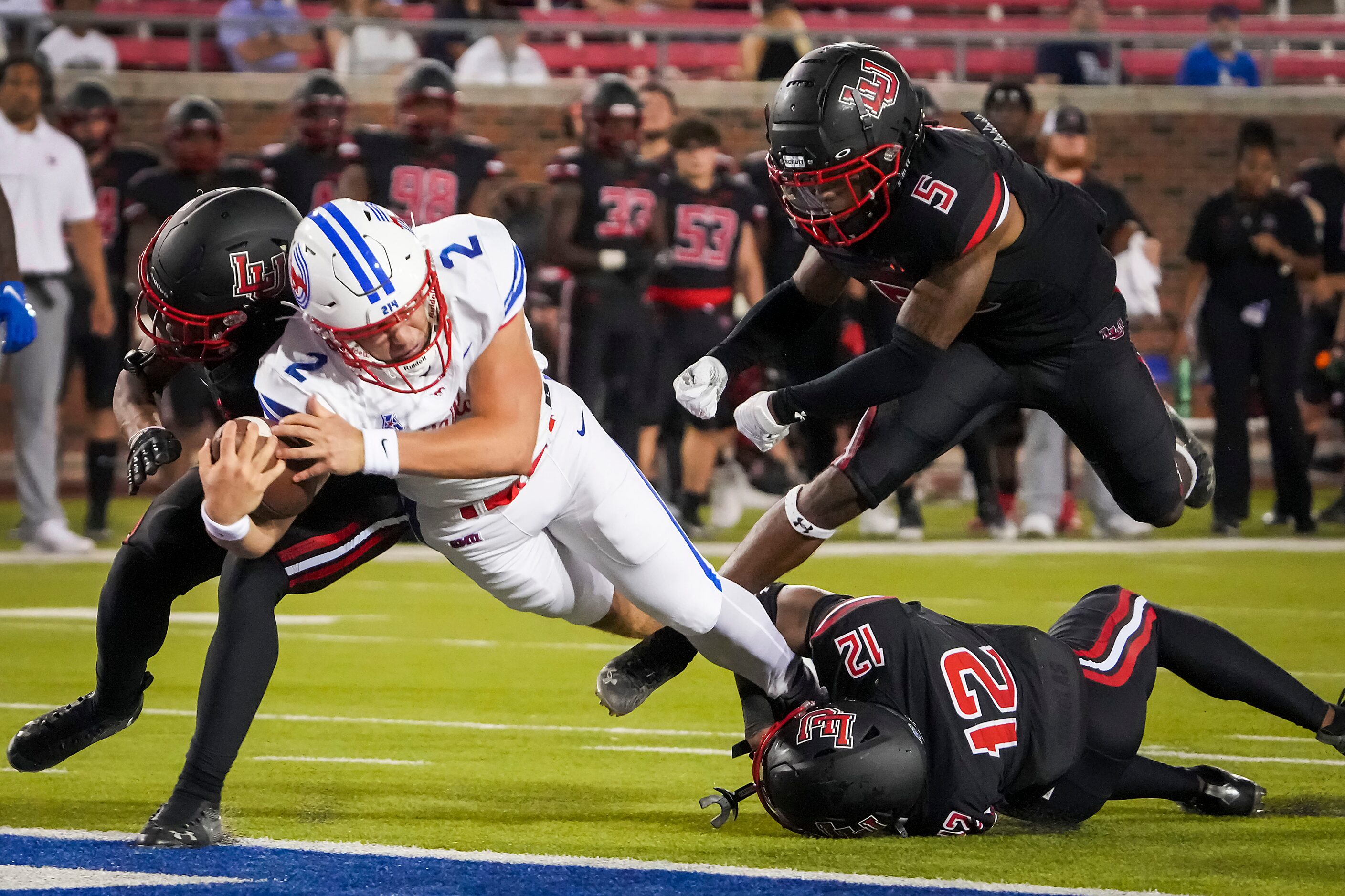 SMU quarterback Preston Stone (2) dives into the end zone to score on a touchdown run past...