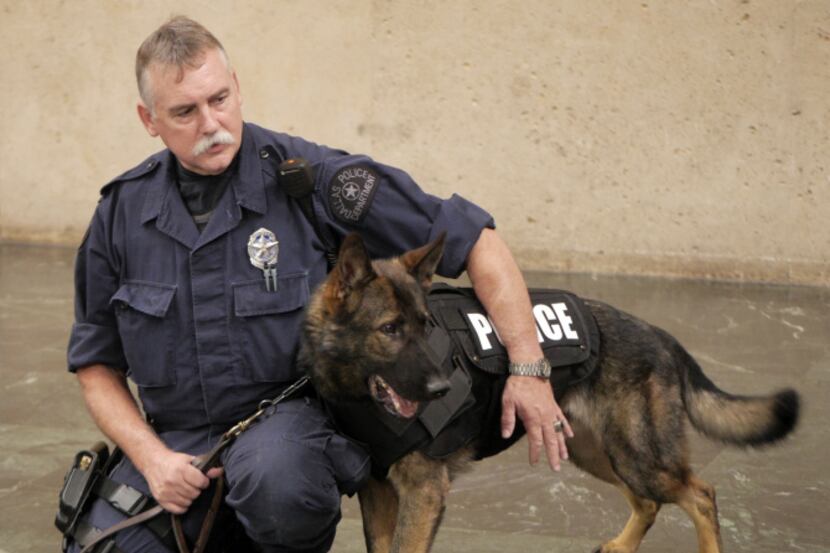 Senior Cpl. Dave Nails of the Dallas Police Department helped Baron show off a Kevlar vest...