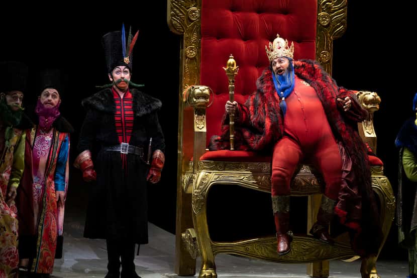 Nikolay Didenko (on throne) performs as King Dodon and Kevin Burdette (at left) performs as...