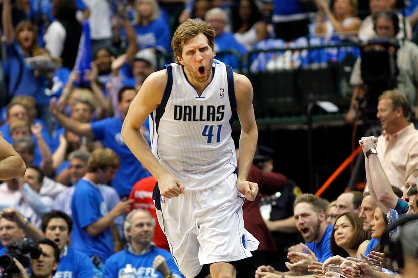 Dallas Mavericks forward Dirk Nowitzki (41) reacts after hitting his first shot of the game...