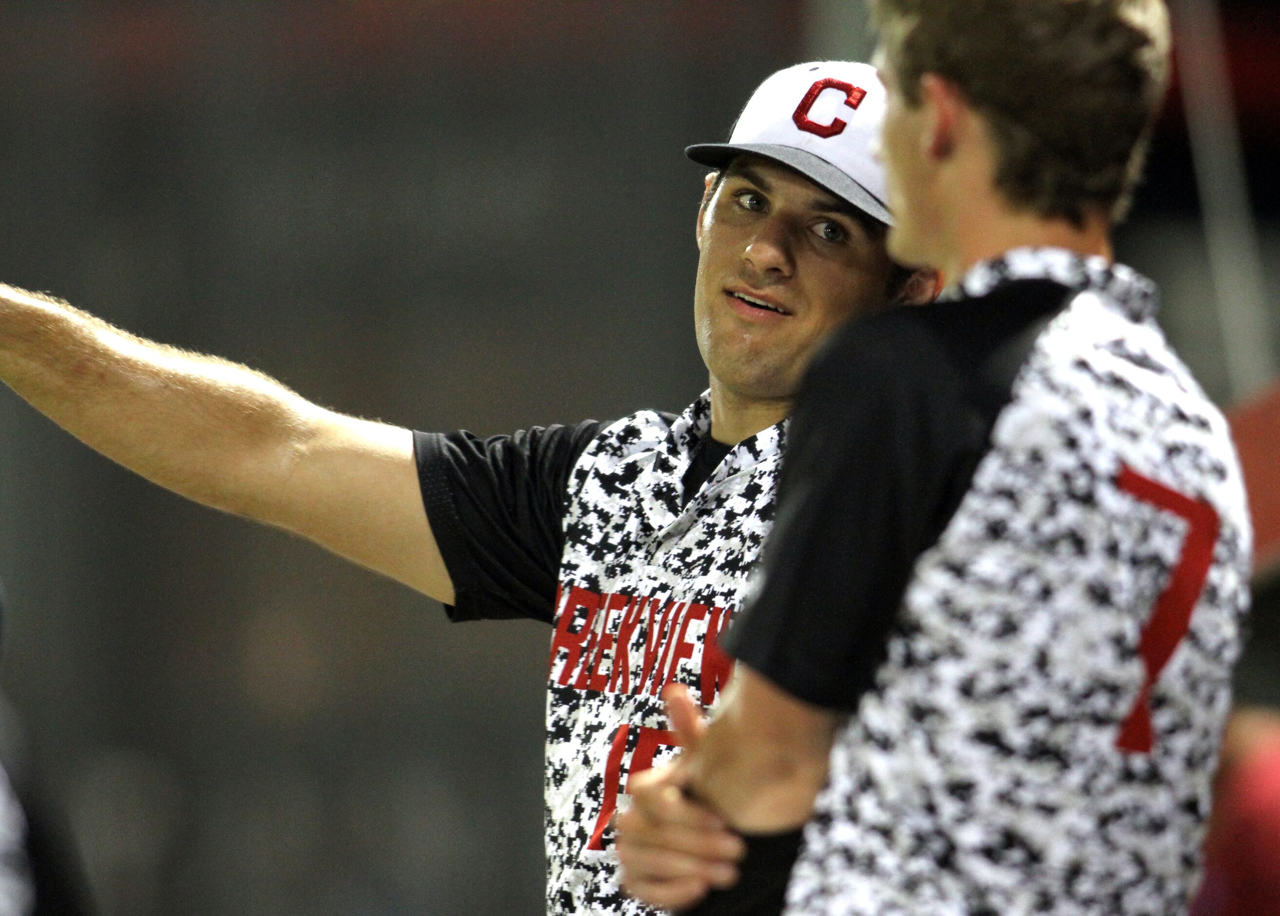 Carrollton Creekview pitcher Brandon White (15) talks with teammate Dawson Wood (7) in the...