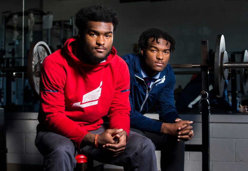 John (left) and Josh Emmanuel, twin football players at Bishop Dune High School, pose for a...