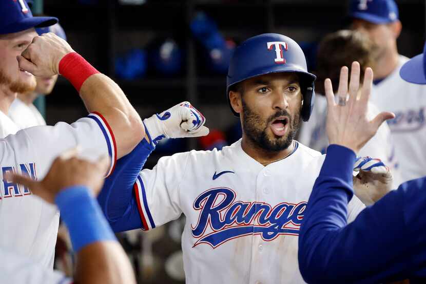 Texas Rangers second baseman Marcus Semien (2) is fired up after hitting a solo home run,...