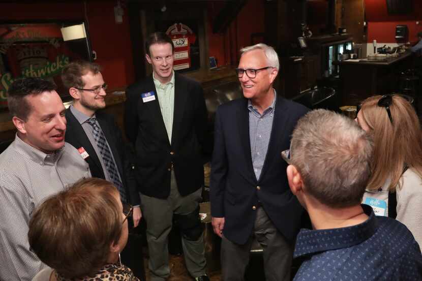 Chris Bell, center, talks to community members during a senate campaign event at The British...