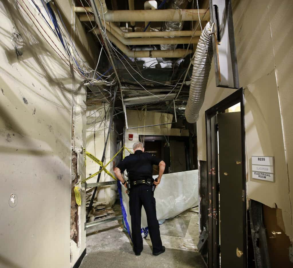 Dallas County College Police Chief Joseph Hannigan stands near the spot where the gunman was...