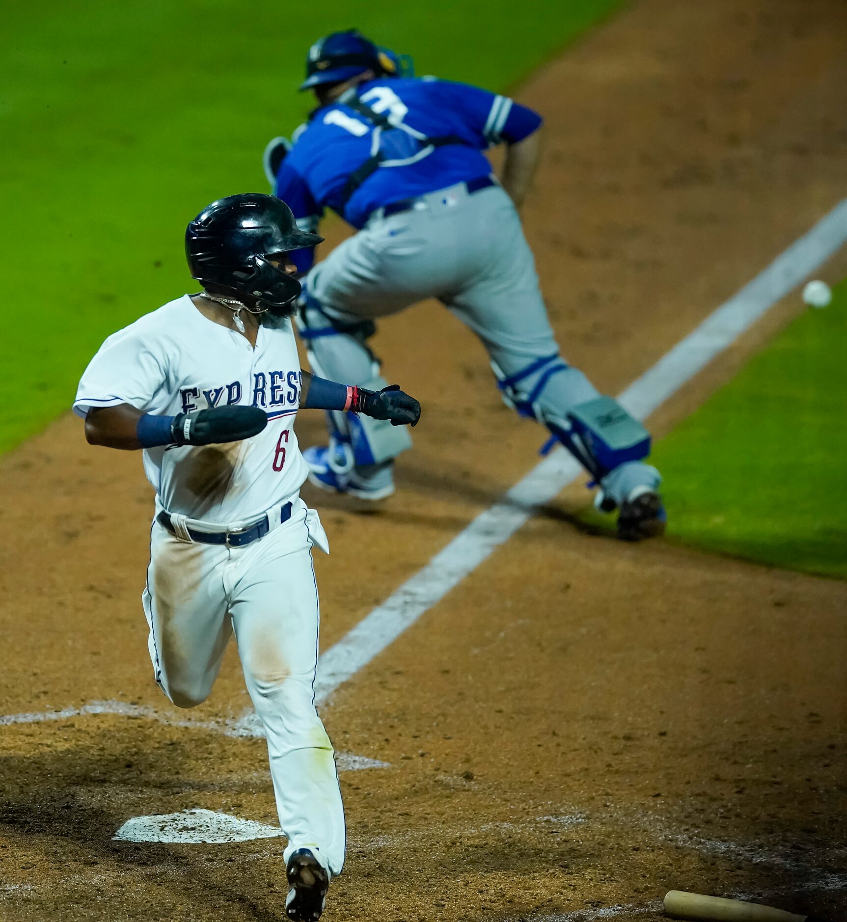 Round Rock Express infielder Yonny Hernandez scores ahead of the throw to Oklahoma City...