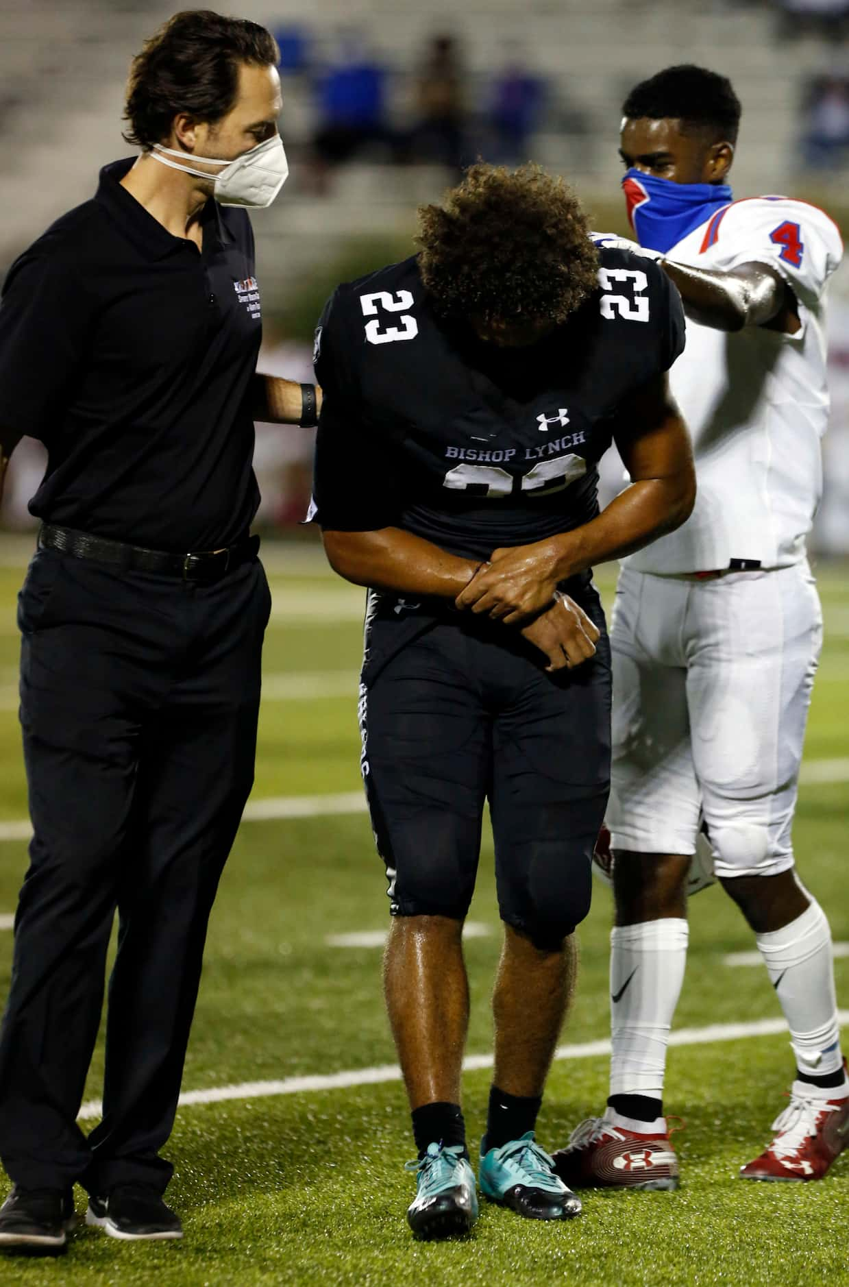 Bishop Lynch’s Isaiah Schmidtke (23) is comforted by Parish Episcopal’s Omari Hayes (4),...