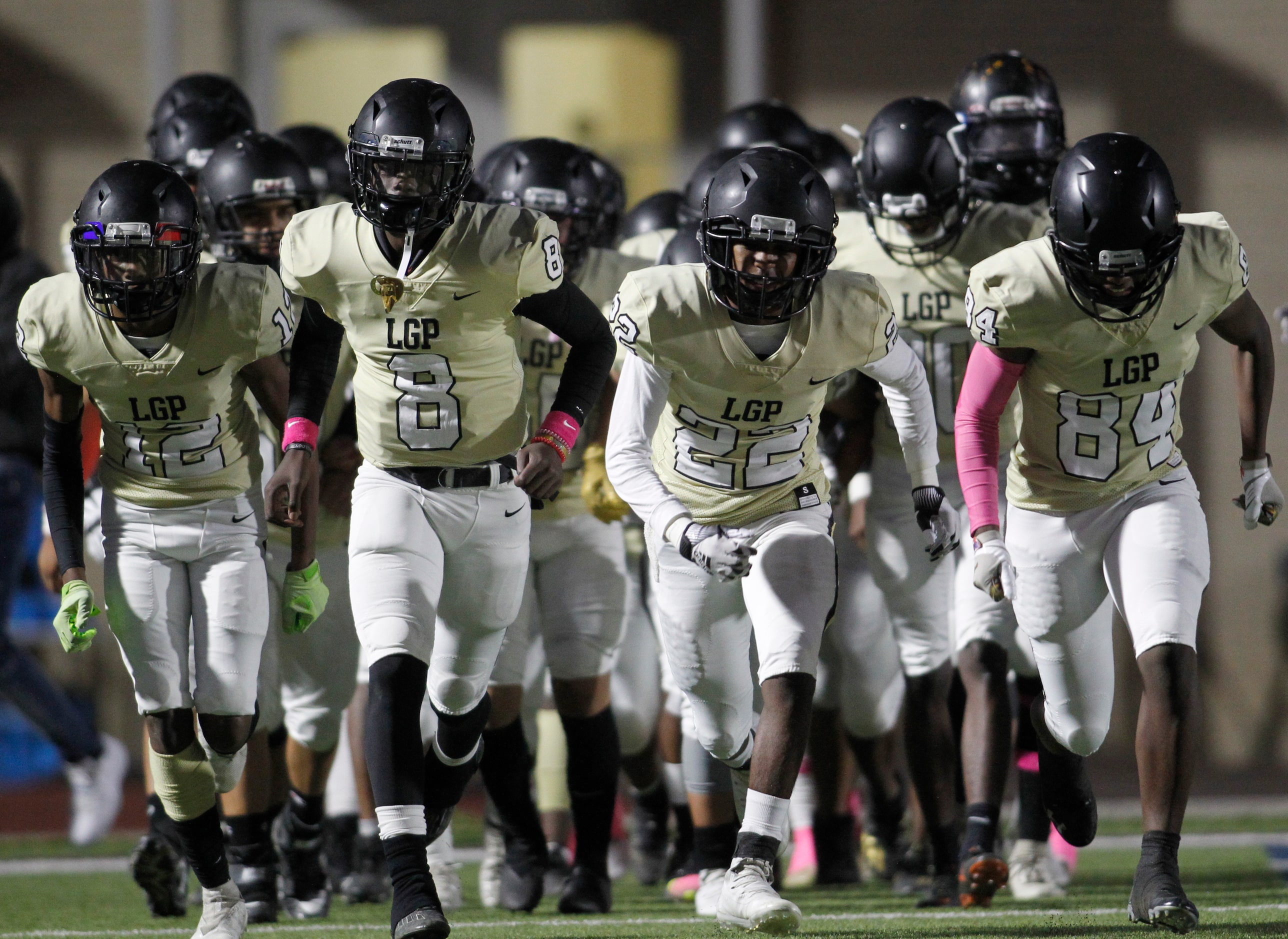 Dallas Pinkston players run onto the field prior to the opening kickoff against Dallas...