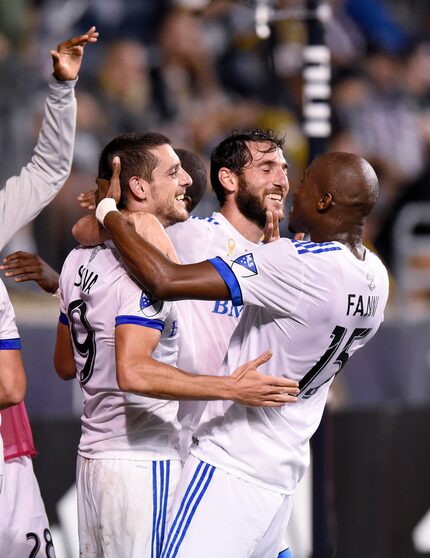 Montreal Impact's Alejandro Silva, left, celebrates after scoring a goal with Ignacio...