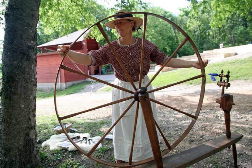 Kris Barndt set up her spinning wheel for a demonstration at the Heard Natural Science...