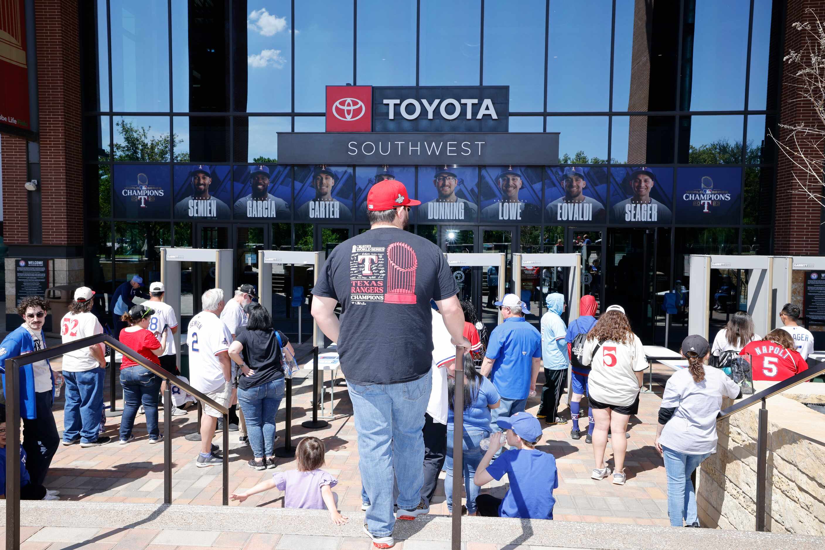 People wait to enter Globe Life Field before the Texas Rangers home opener against the...