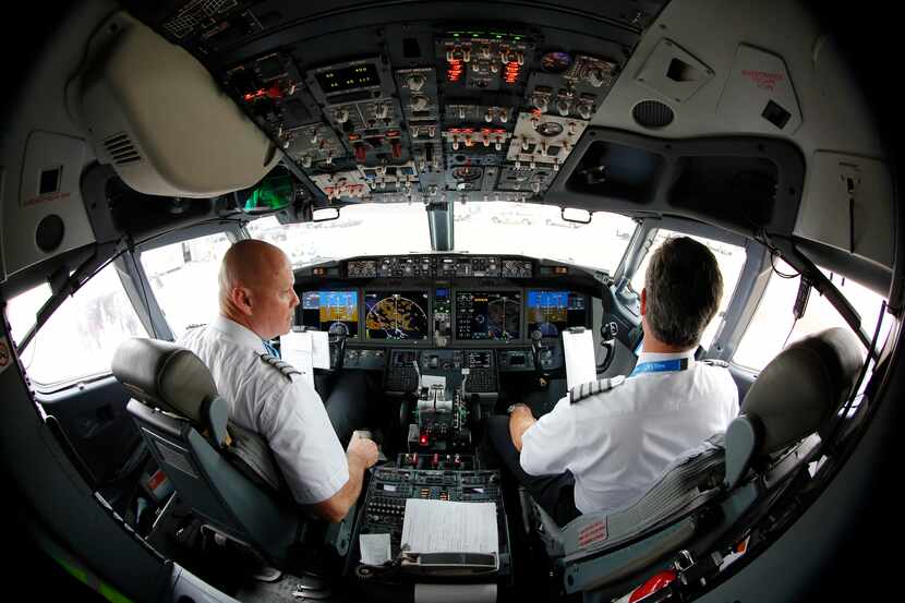 American Airlines Captain Pete Gamble (left) and First Officer John Konstanzer perform a...