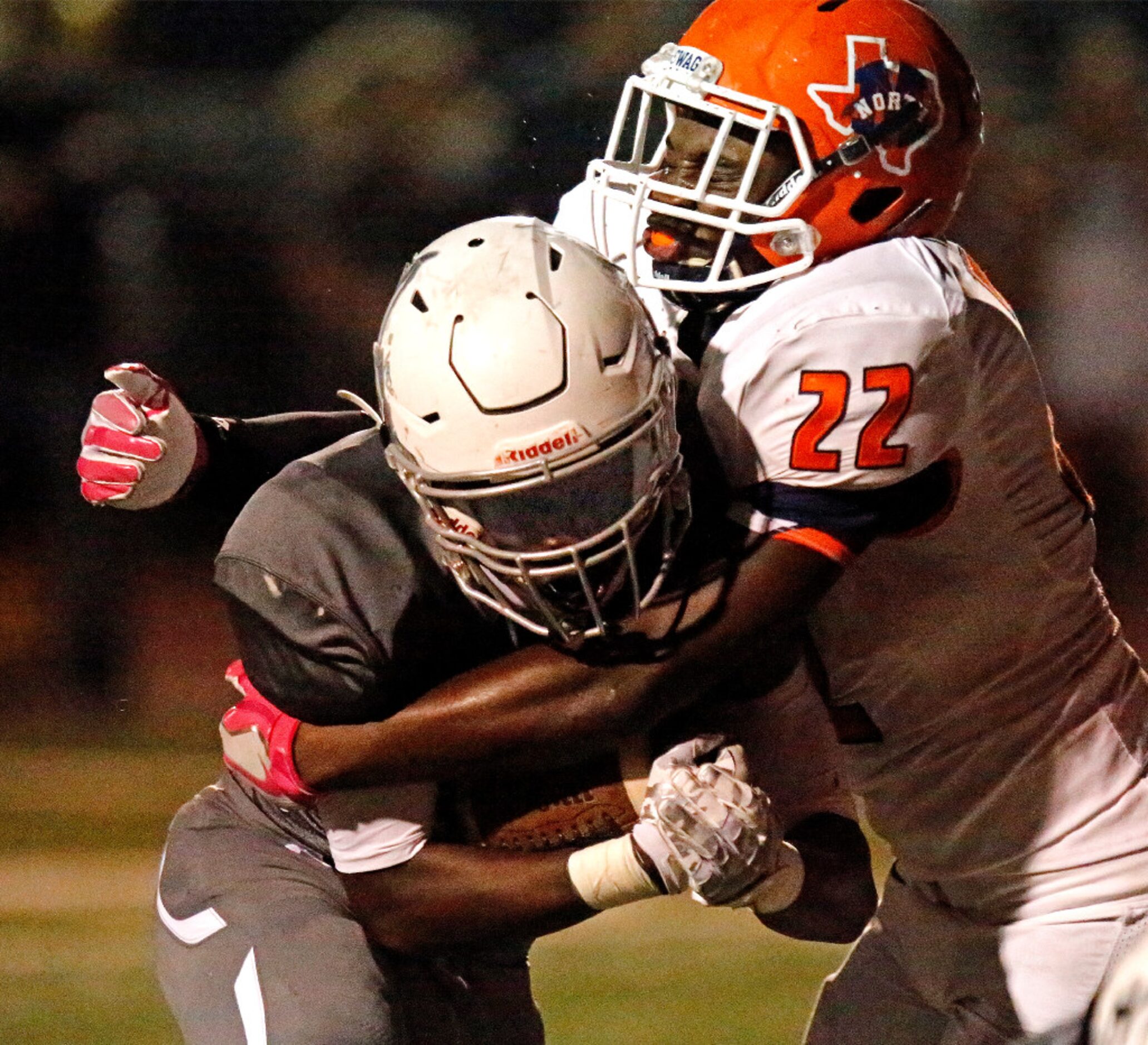 Prosper High School running back Wayne Anderson (23) is hit and brought down by McKinney...