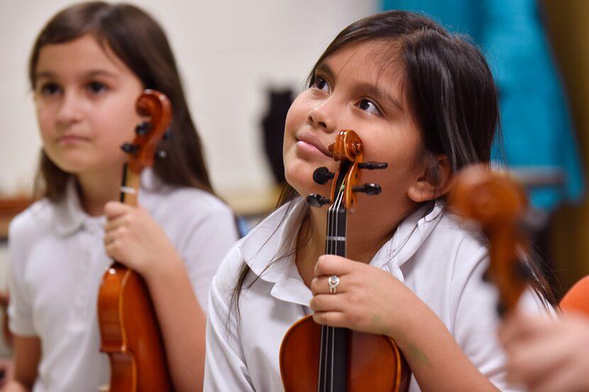 Mayte Mendoza, center, listens to instructions from teacher Nicole Melki. The 8-year-old...