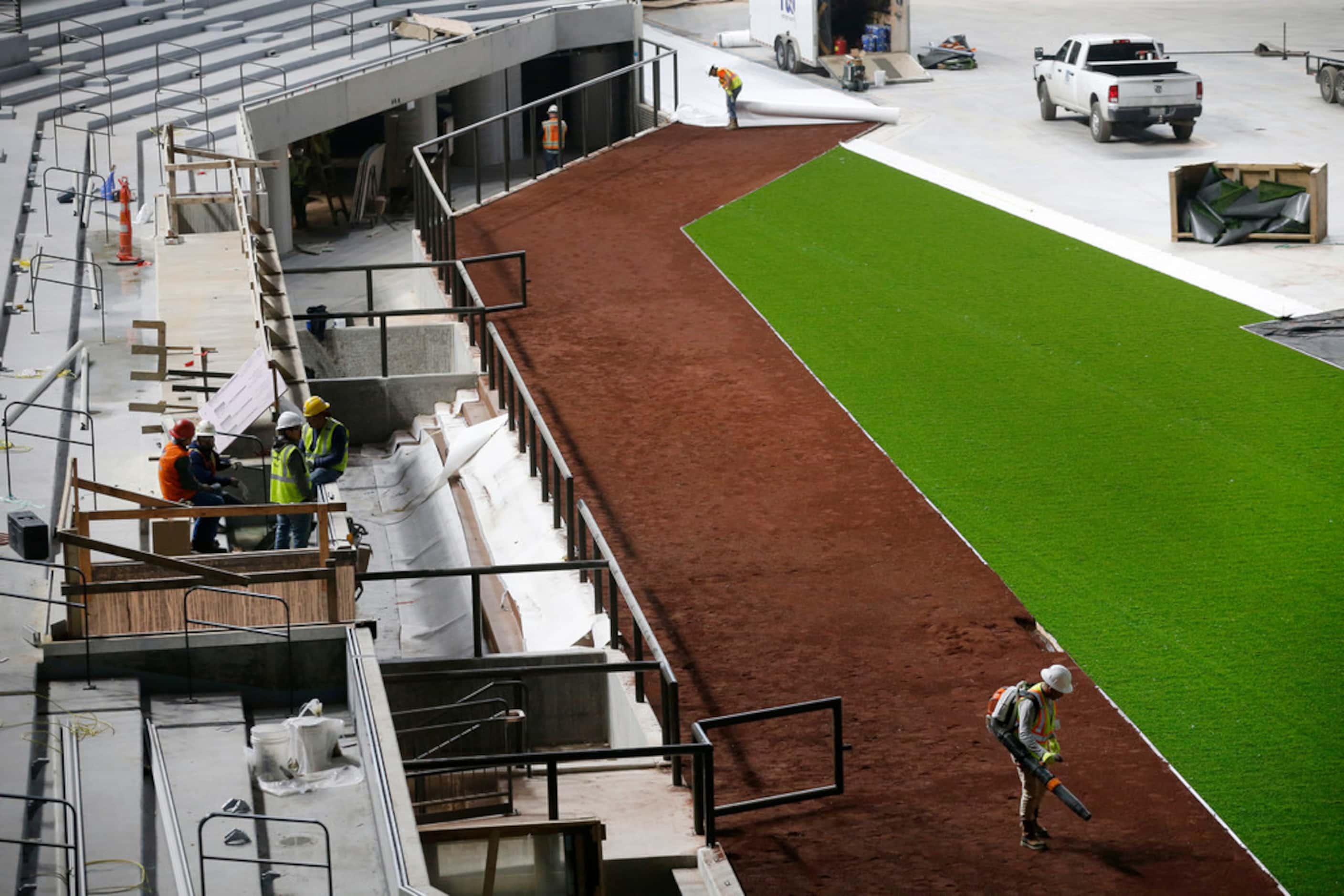 The synthetic grass by Shaw Sports Turf and infield dirt are being installed at Globe Life...