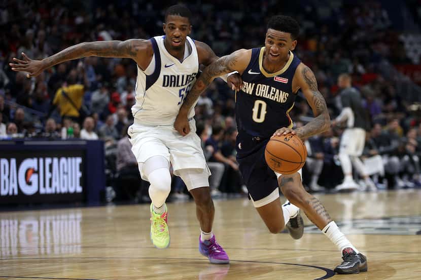 Nickeil Alexander-Walker of the New Orleans Pelicans drove the ball around Delon Wright of...