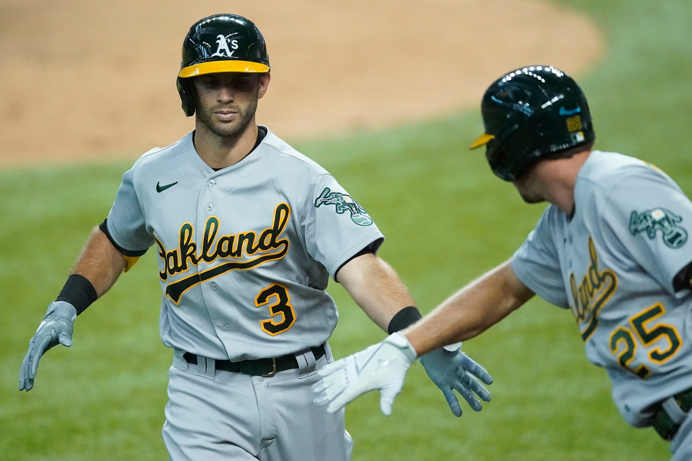 Oakland Athletics third baseman Tommy La Stella celebrates with right fielder Stephen...