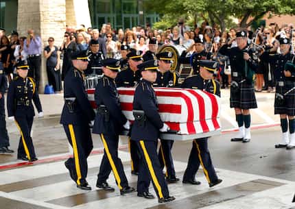 The Dallas Police Honor Guard carried the flag-draped casket of Dallas police Officer...
