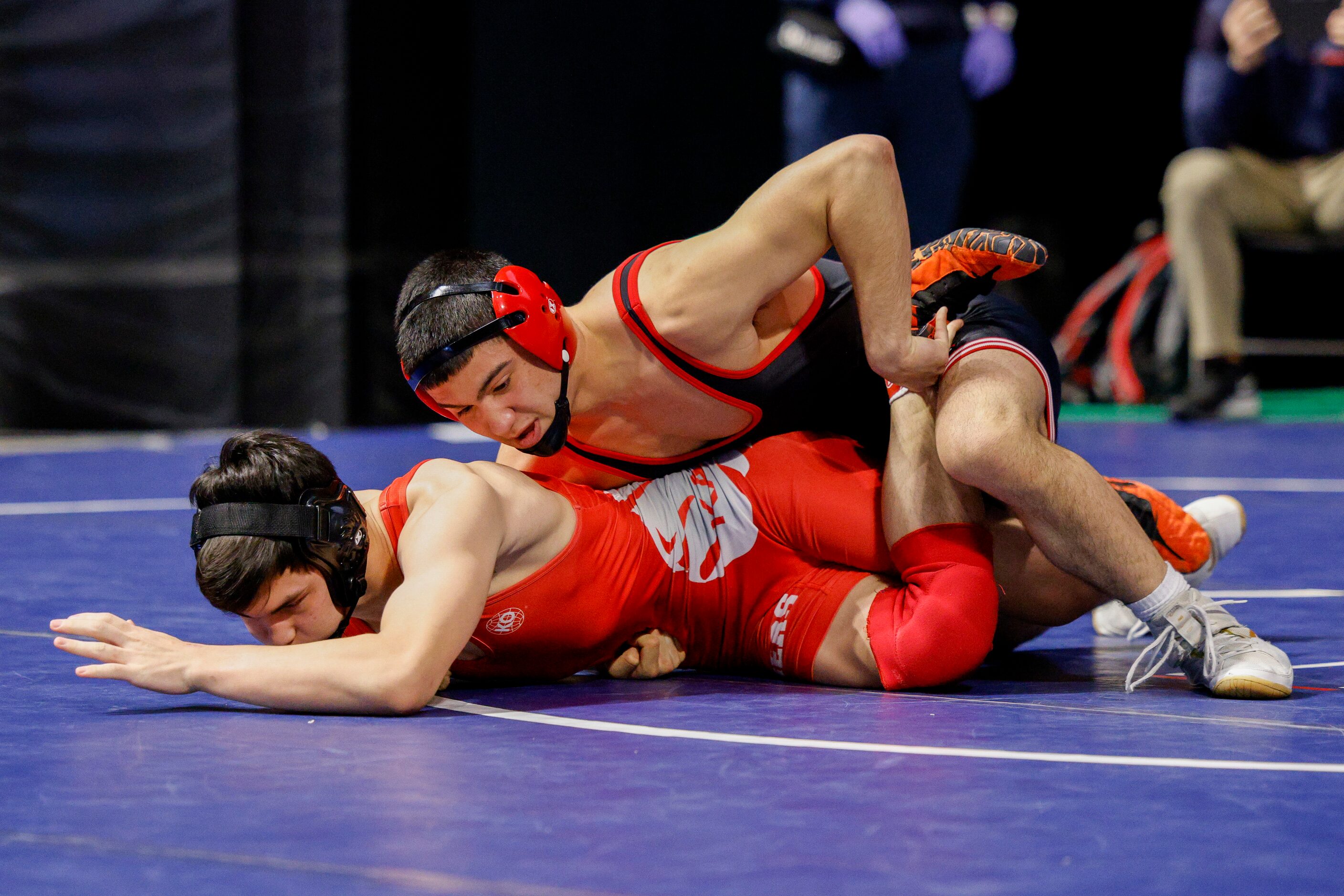 Kade Moore of Allen (left) wrestles Connor Timmons of Katy. during a quarterfinal match of...