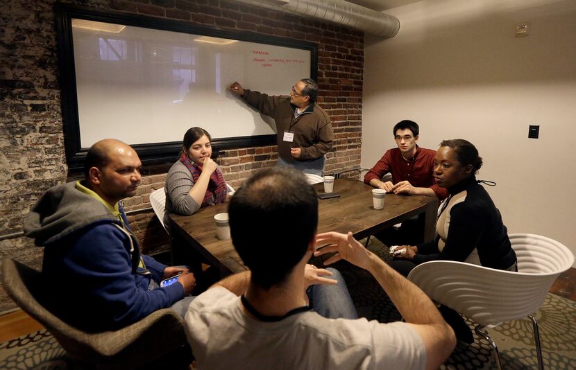 In this Saturday, Feb. 8, 2014 photo, participants Abhishek Agarwal, clockwise from left,...