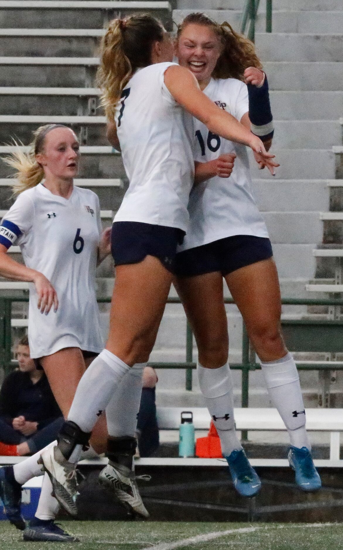 Highland Park midfielder EmJ Cox (7) congratulates midfielder Quinn Cornog (16) after Cornog...