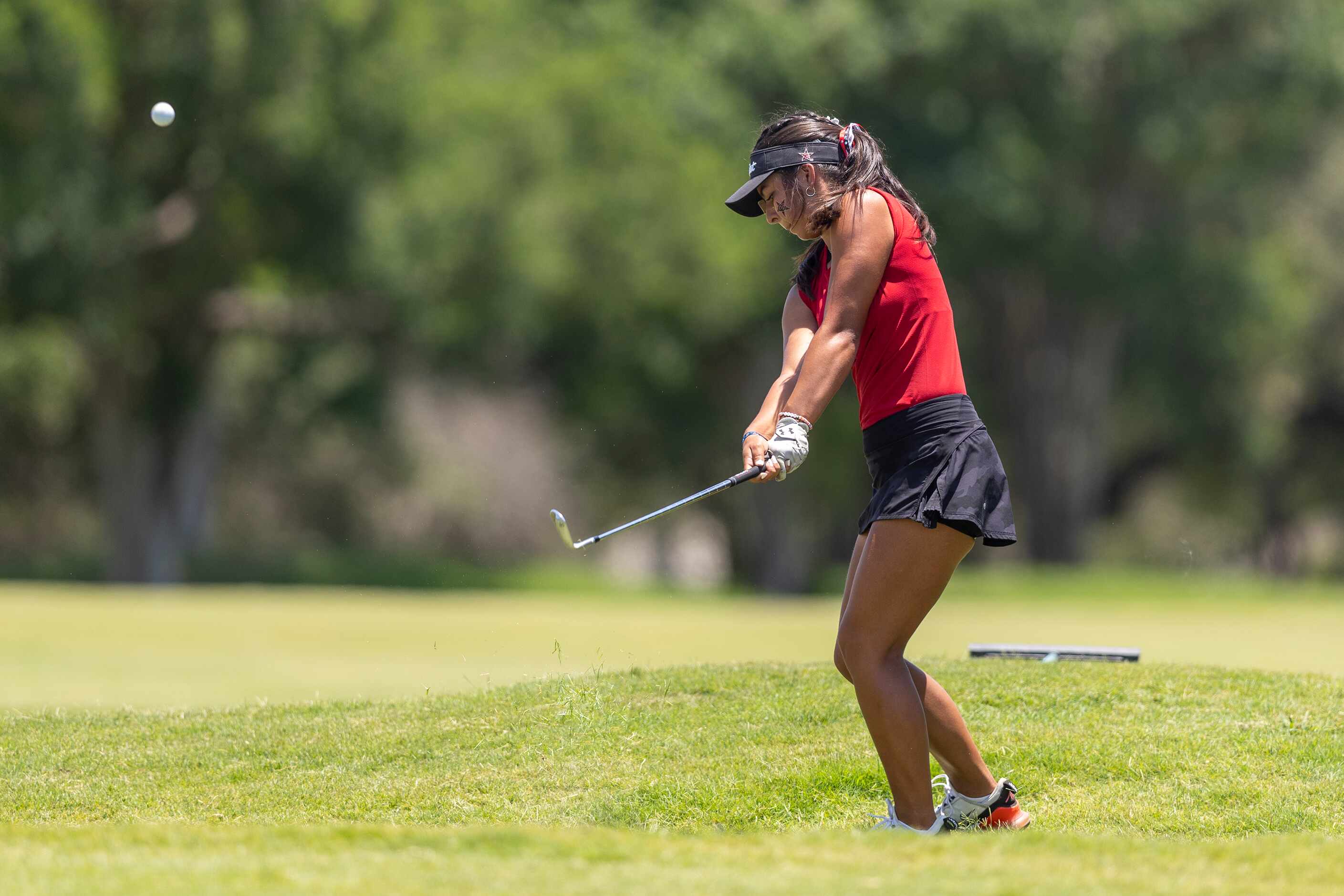 Coppell’s Lauren Rios hits from the 18th fairway during the 6A girls state golf tournament...