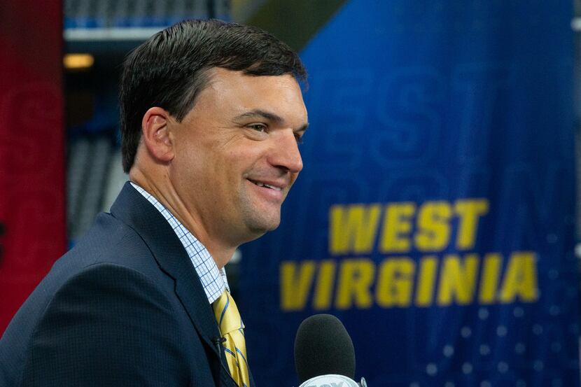 West Virginia University head football coach Neal Brown speaks with Fox Sports during the...