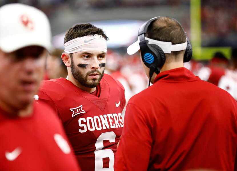 Oklahoma Sooners head coach Lincoln Riley (right) visits with quarterback Baker Mayfield (6)...