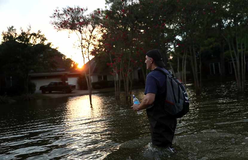  Samir Novruzov walks through a flooded street Monday in Katy, Texas. Over a week after...