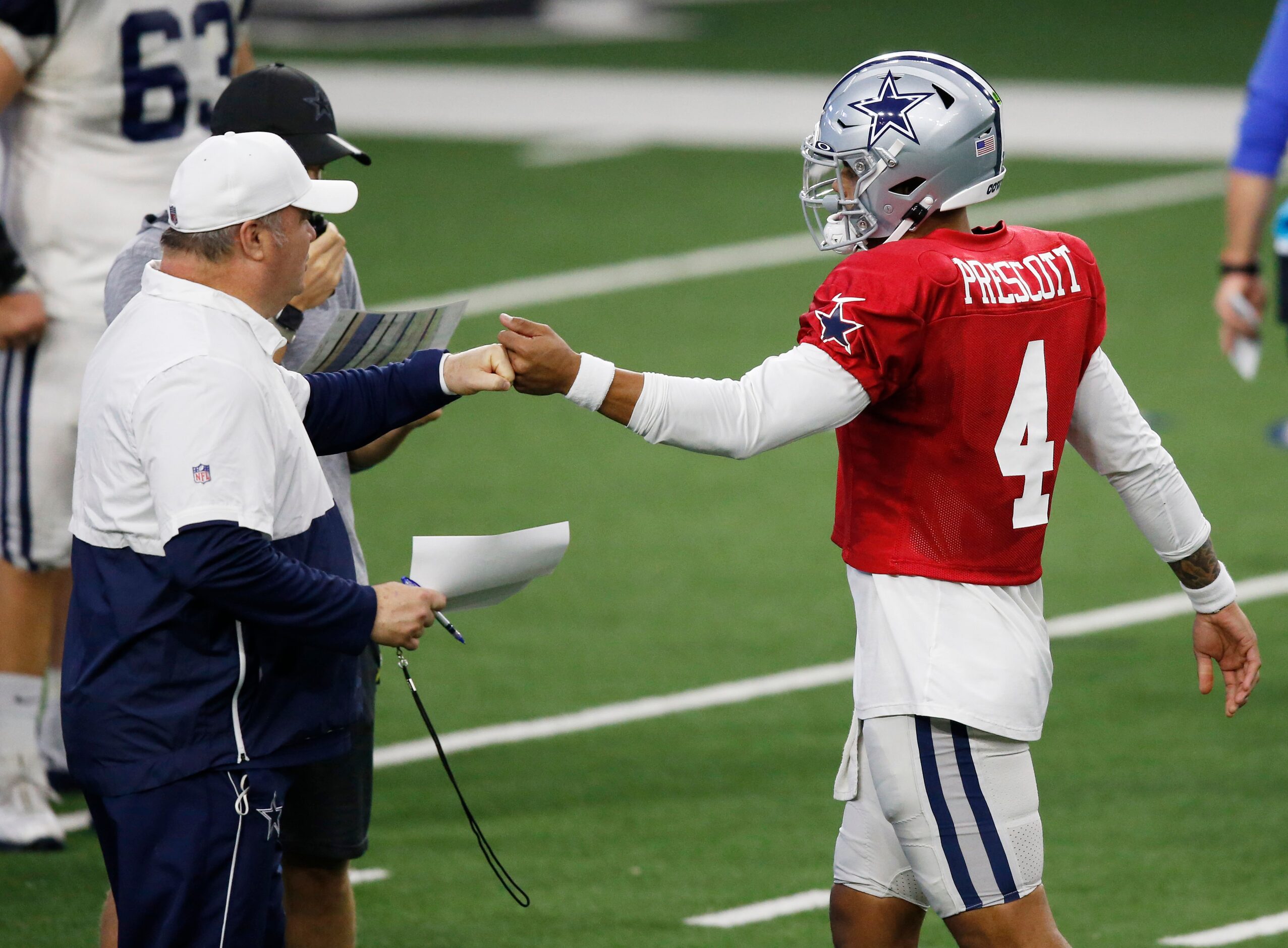 Dallas Cowboys head coach Mike McCarthy and Dallas Cowboys quarterback Dak Prescott (4)...